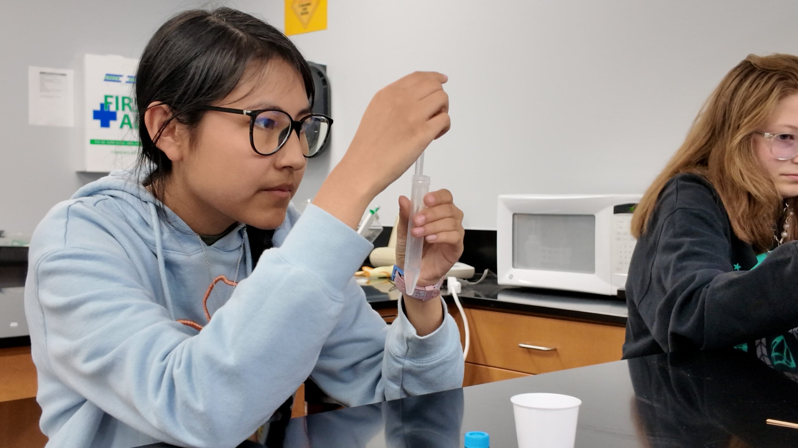 Biomedical Sciences student holding a test tube.