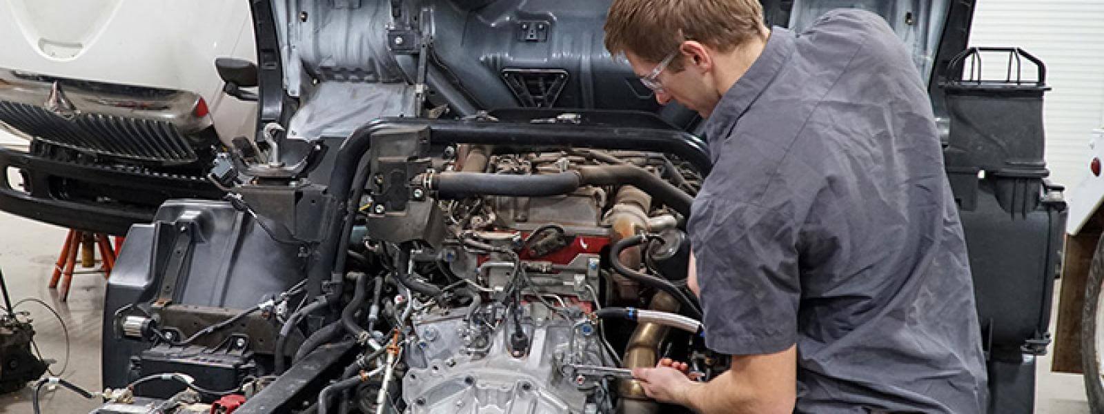 diesel technology student works on an engine
