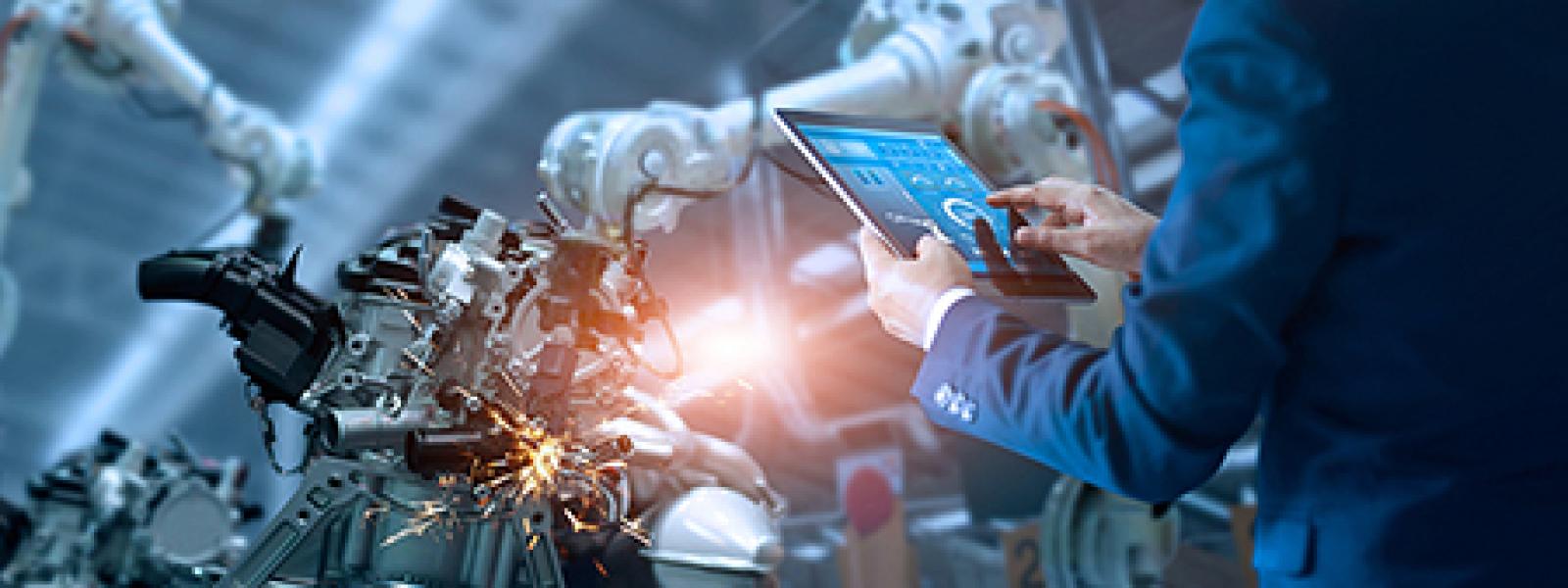 industrial automation tech reads info on a tablet