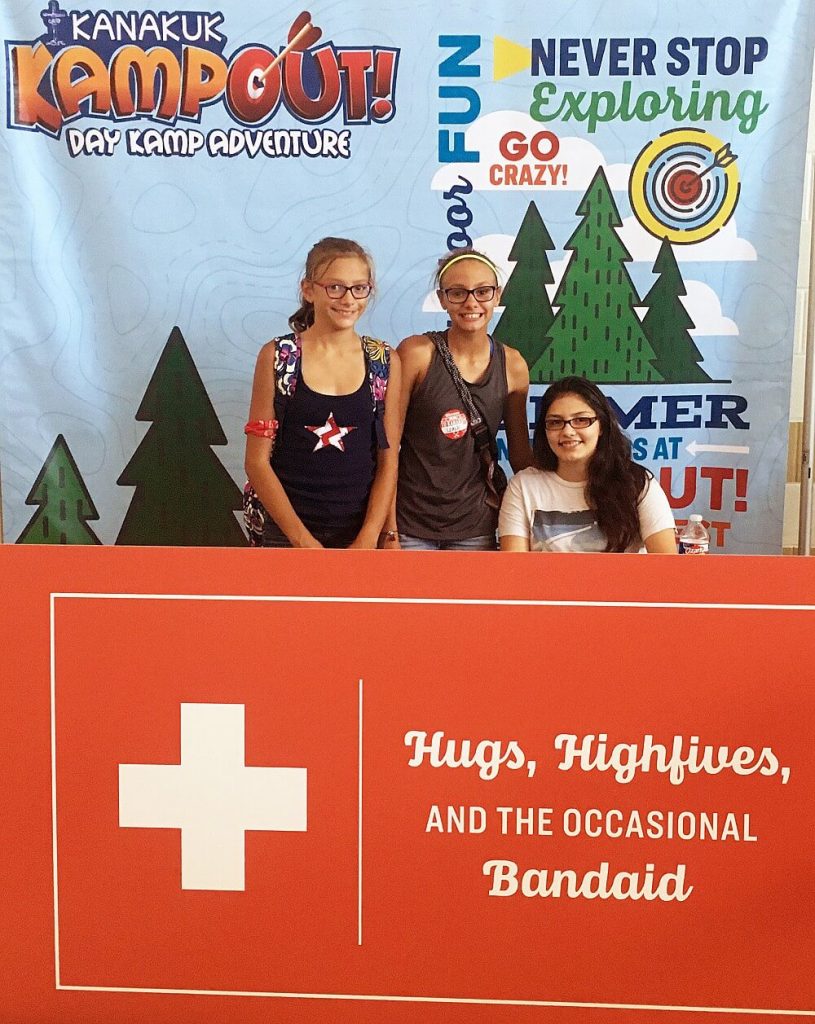 Students pose with Day Camp graphic