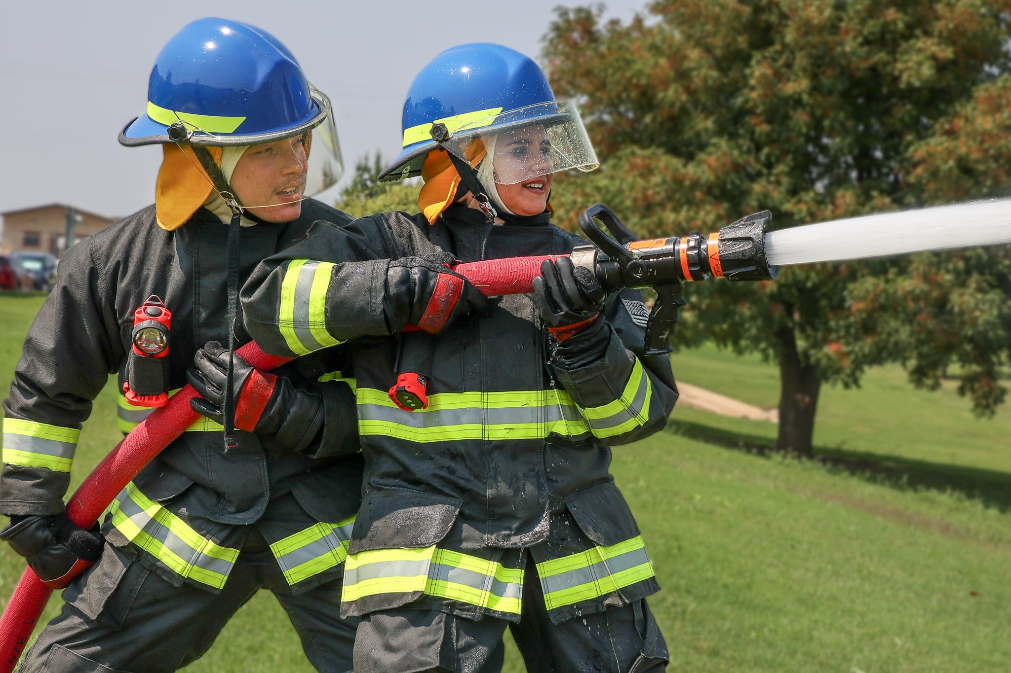 Two Firefighter students training with a hose.