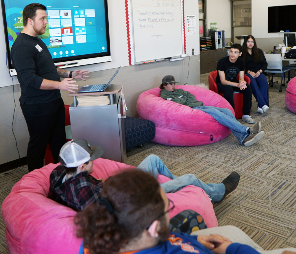 Former CV Tech student David Deskin stands in front of a handful of current students who are enrolled in the school's Project Connect program.